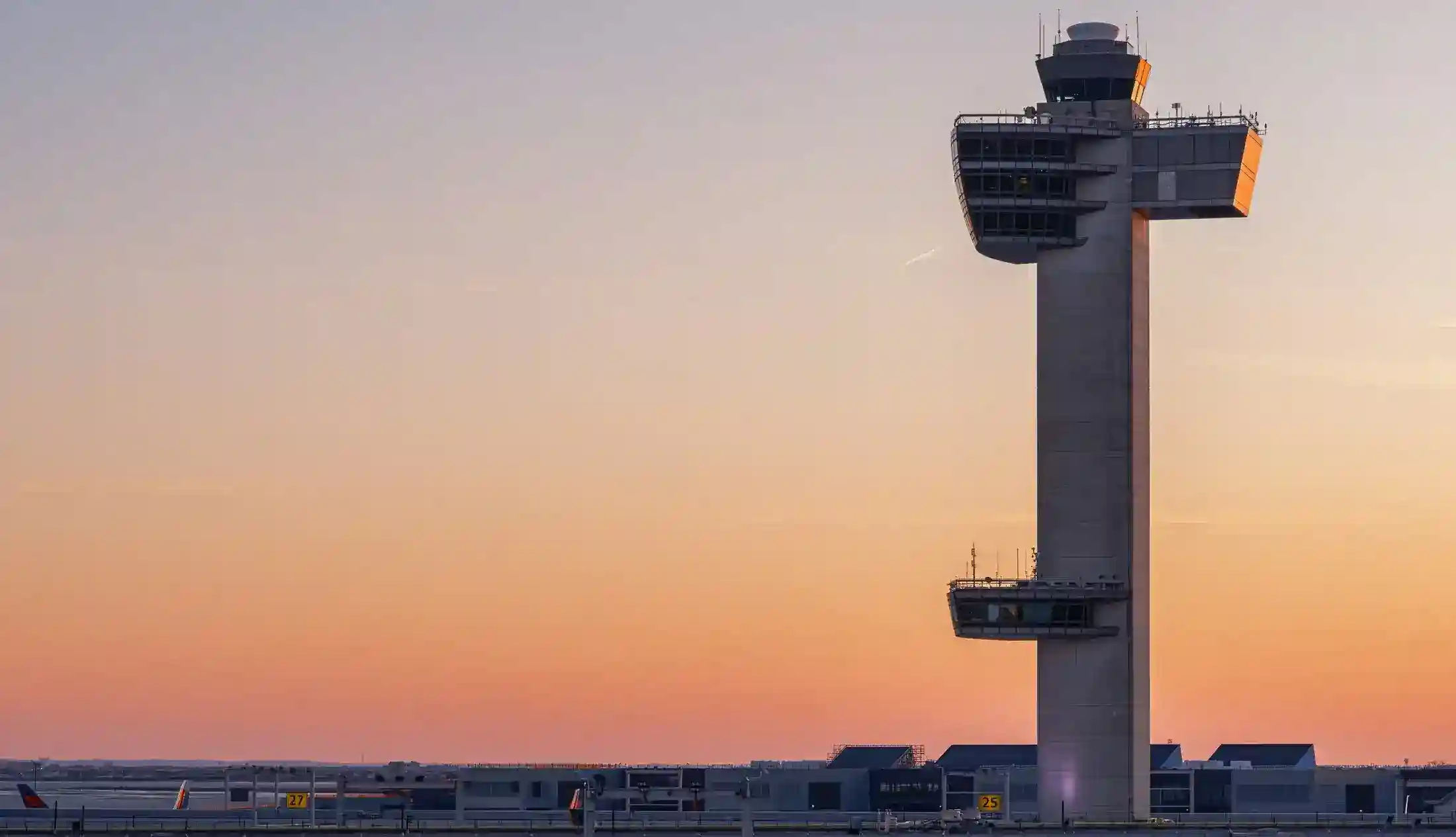Airport control tower at dusk above the terminal