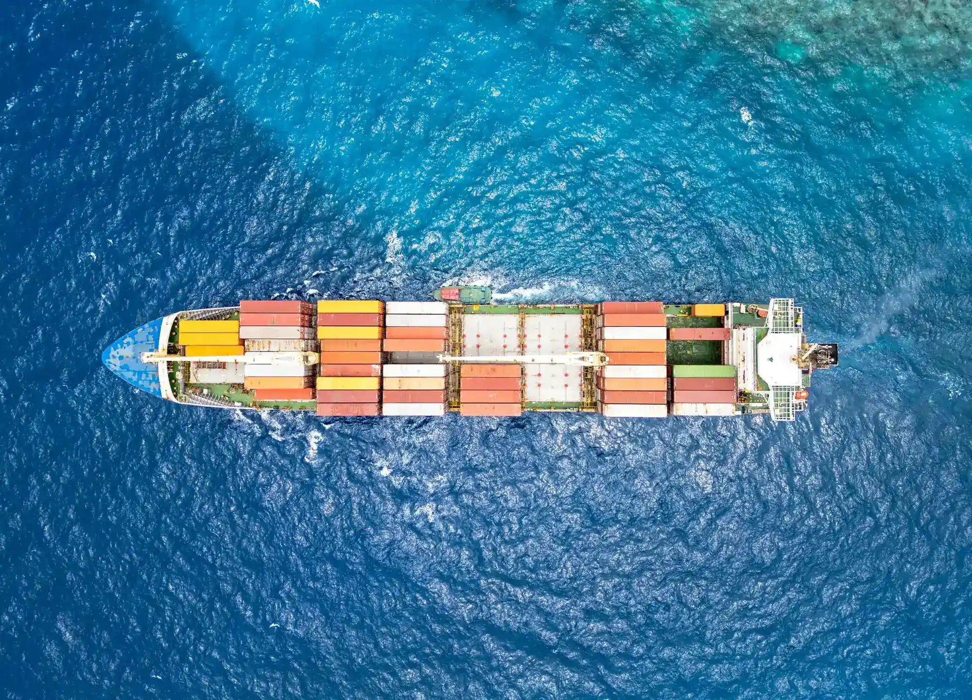 Overhead view of a container ship crossing open water