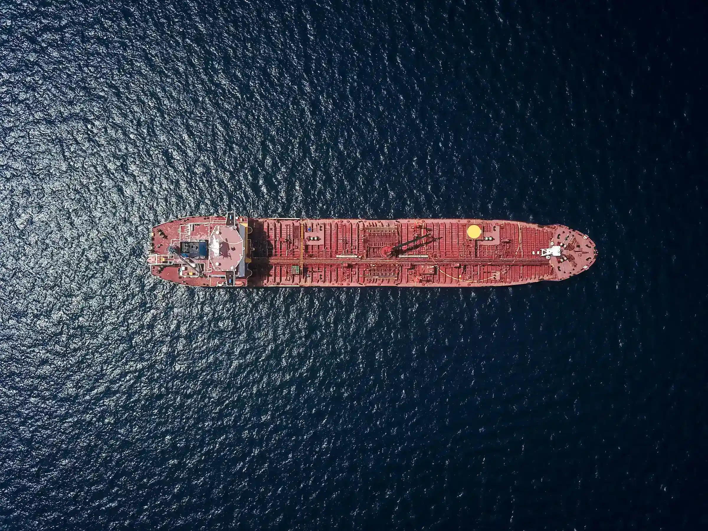 Overhead view of a tanker at anchor in deep blue water